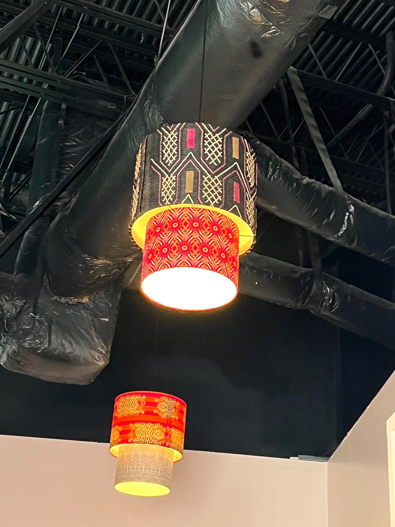 bright colorful tiered lampshade and lights hung on ceiling