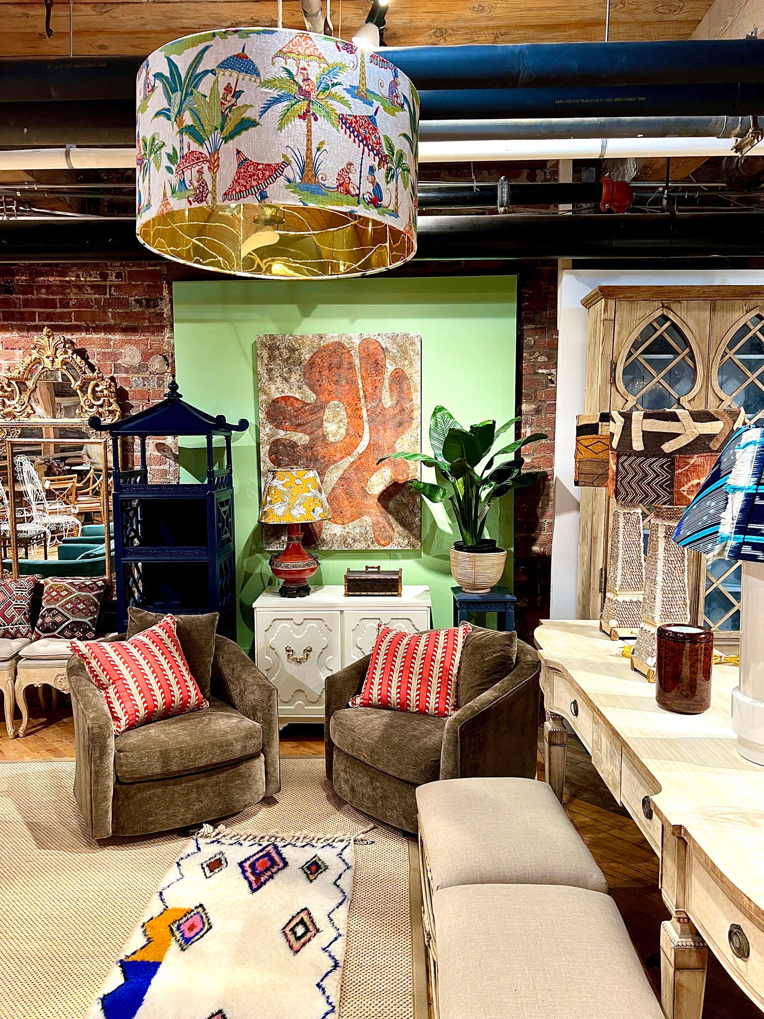 monkey fabric drum shade hung up in a furniture store