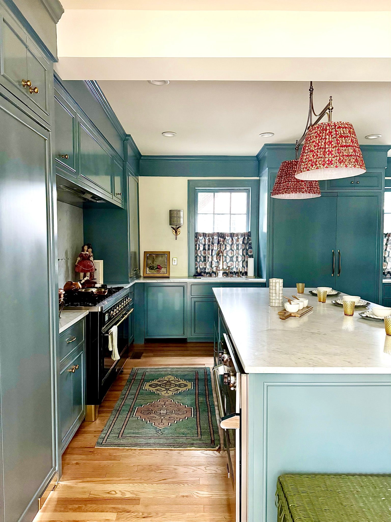 pleated pink hung lighting in a blue kitchen