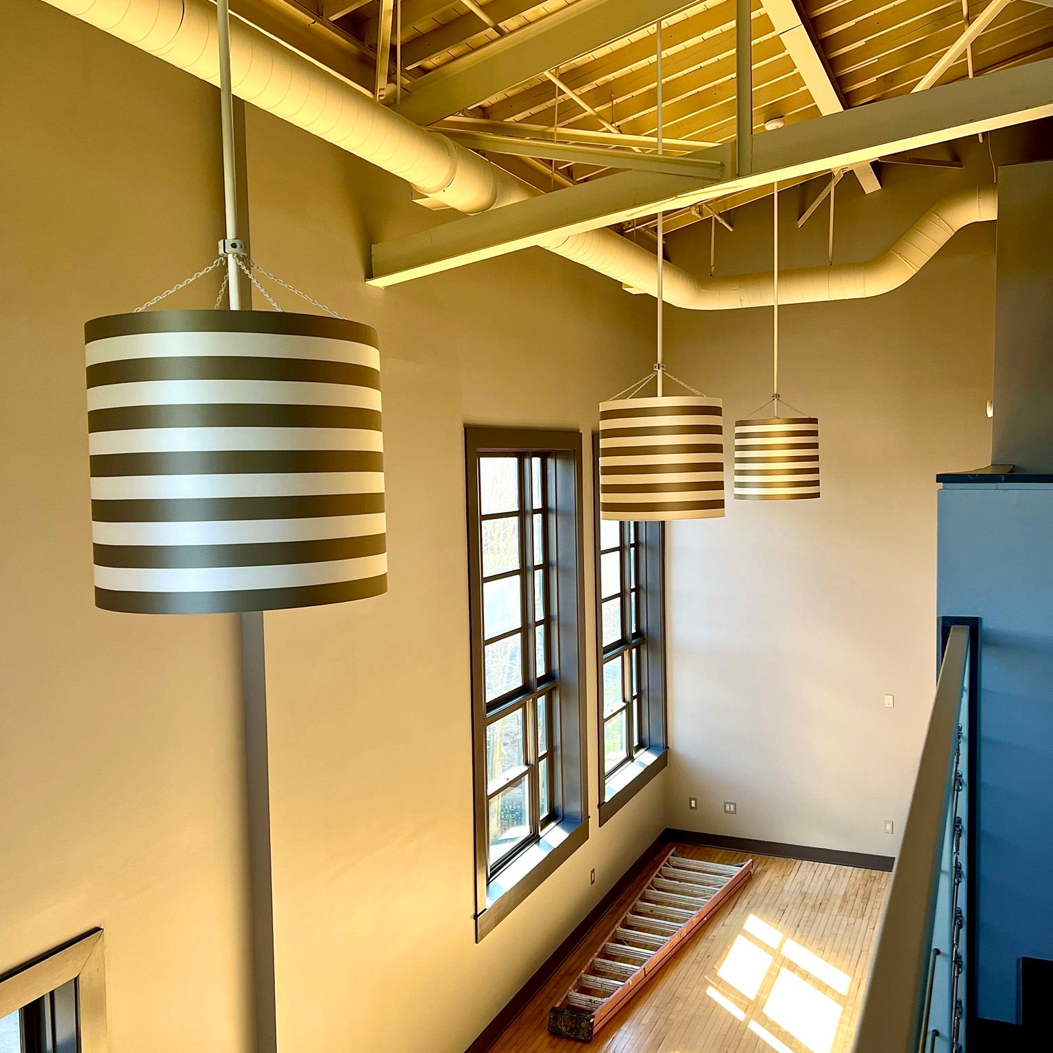 black and beige drum lighting hung