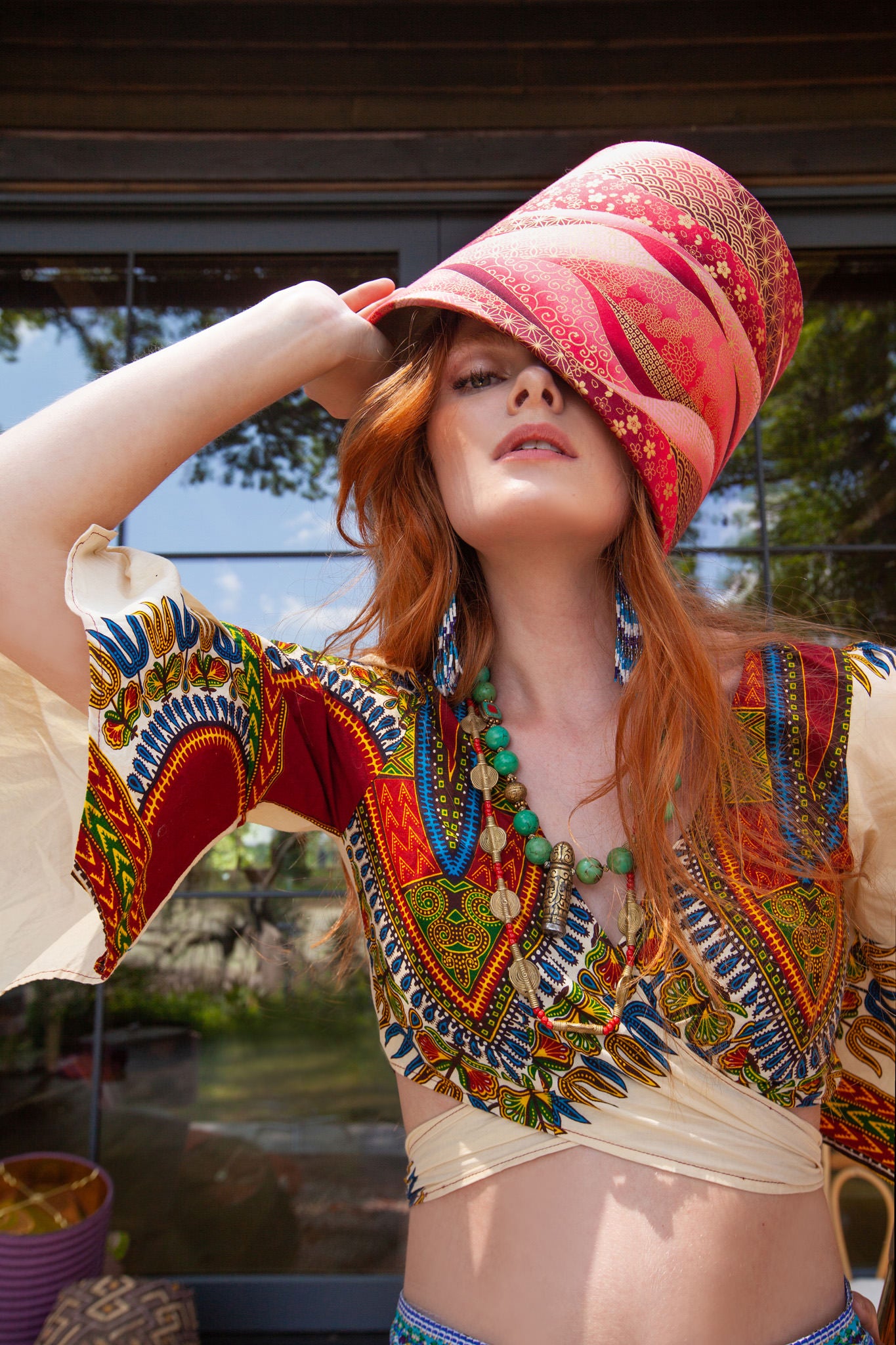 girl with red hair with a lampshade on her head like a hat