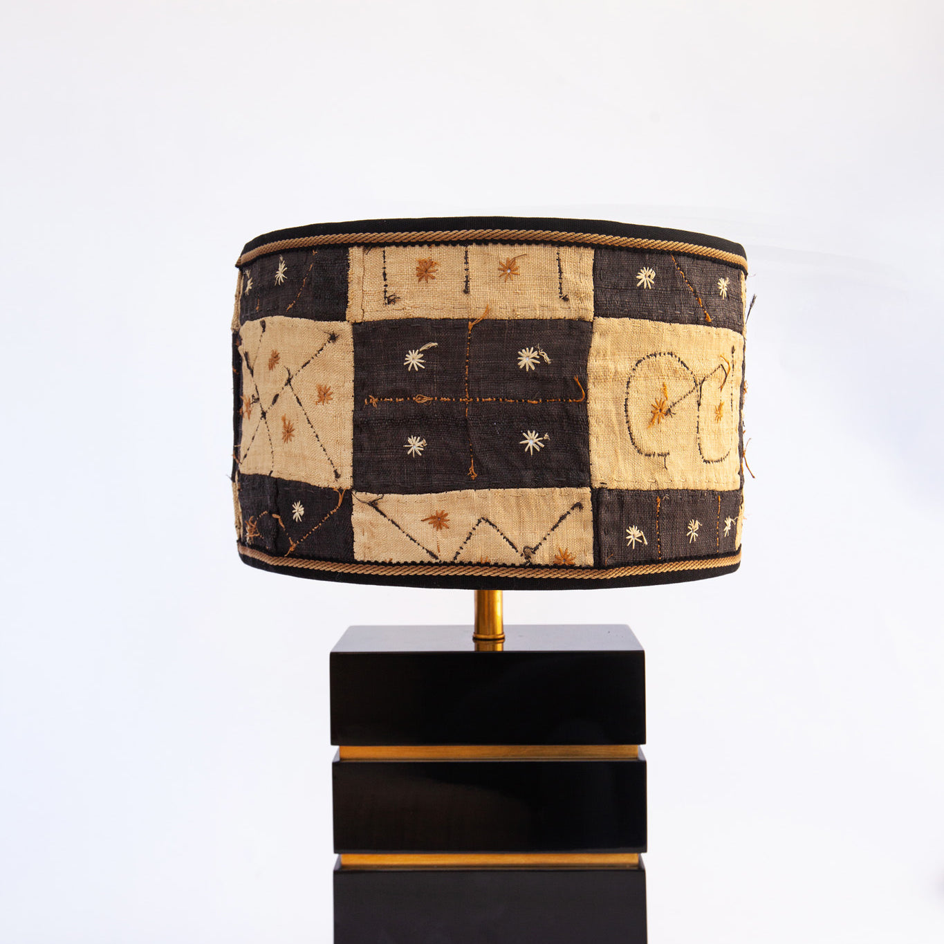 kuba cloth lampshade on gold and black lamp