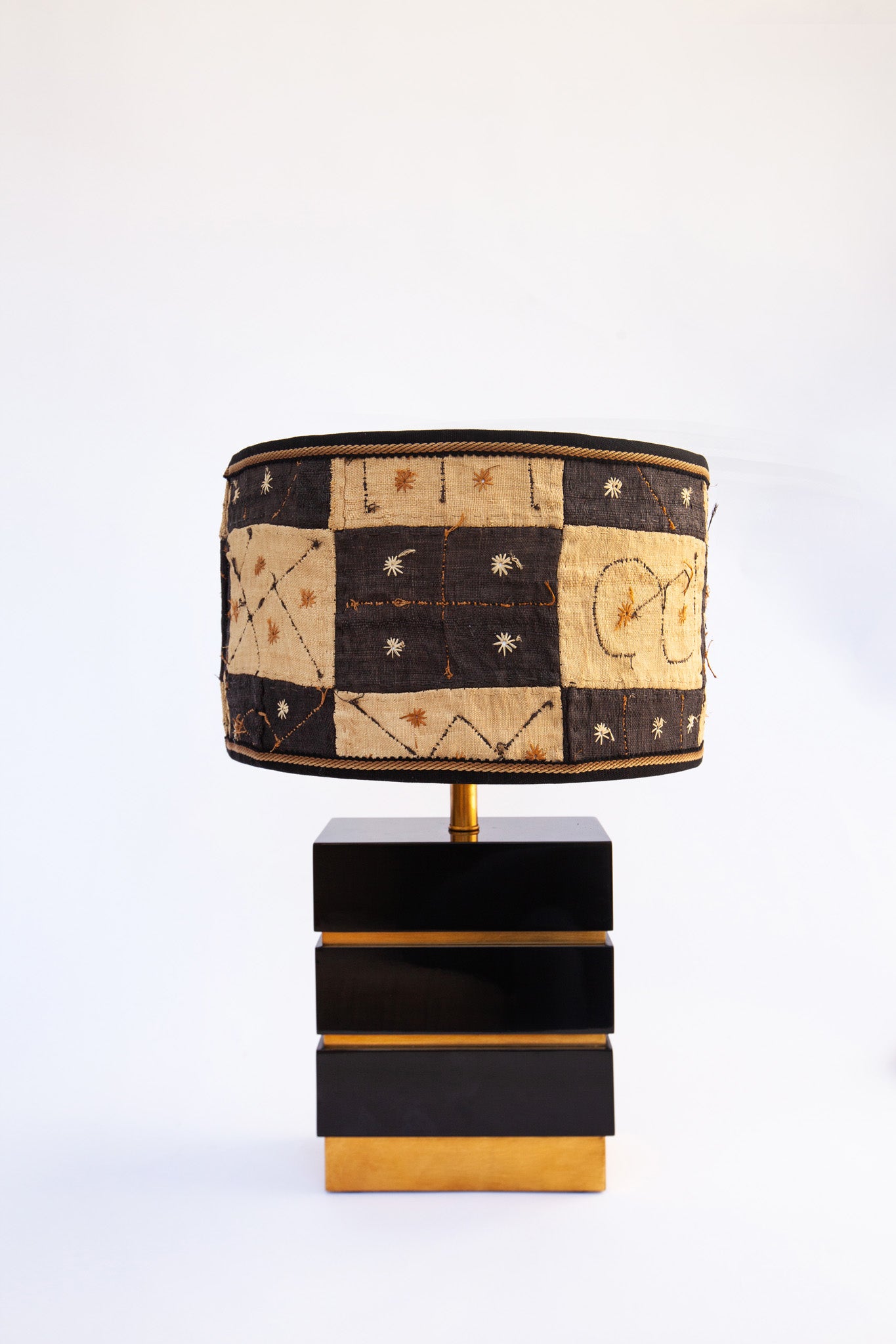 kuba cloth lampshade on gold and black lamp