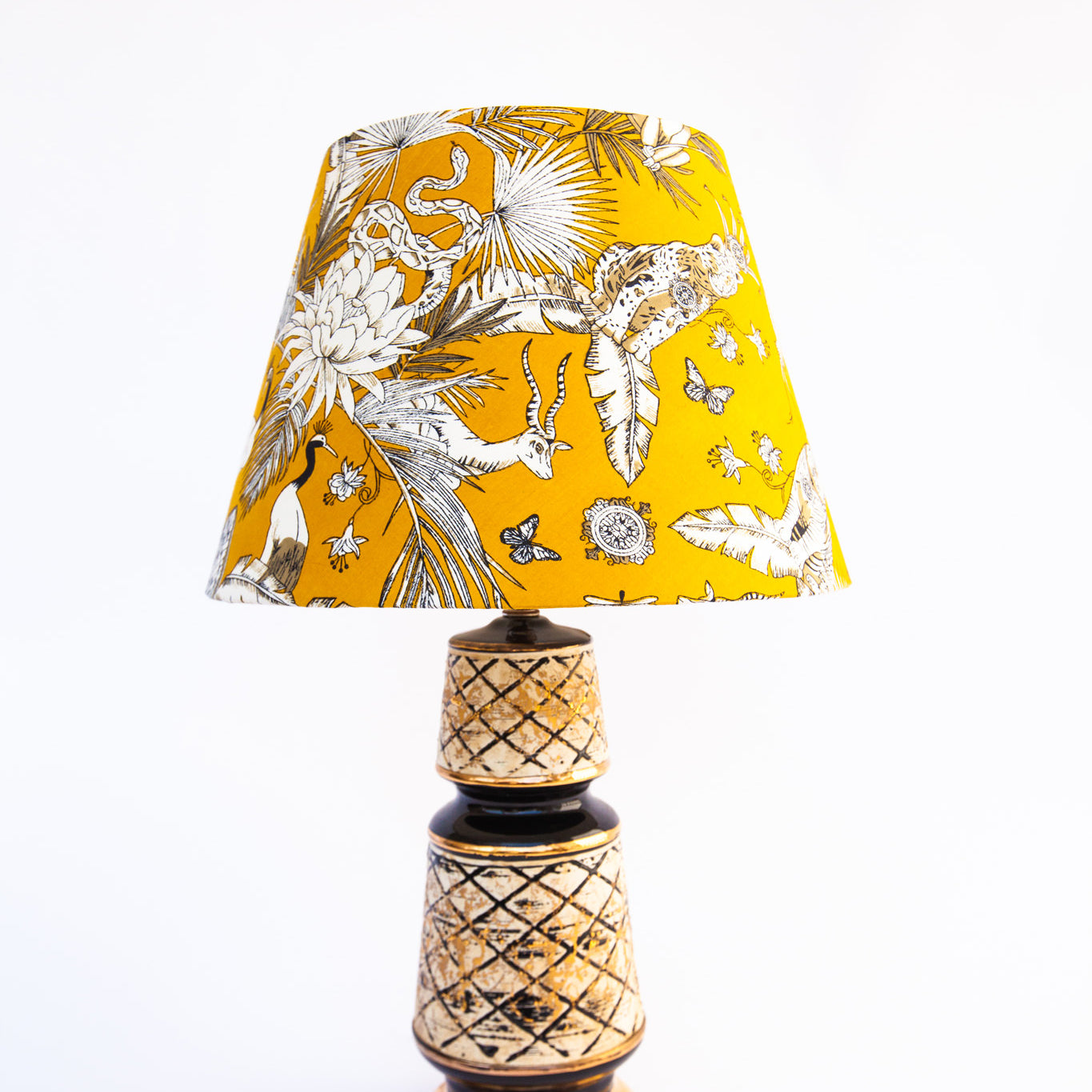 white and mustard yellow lampshade on black and beige lamp