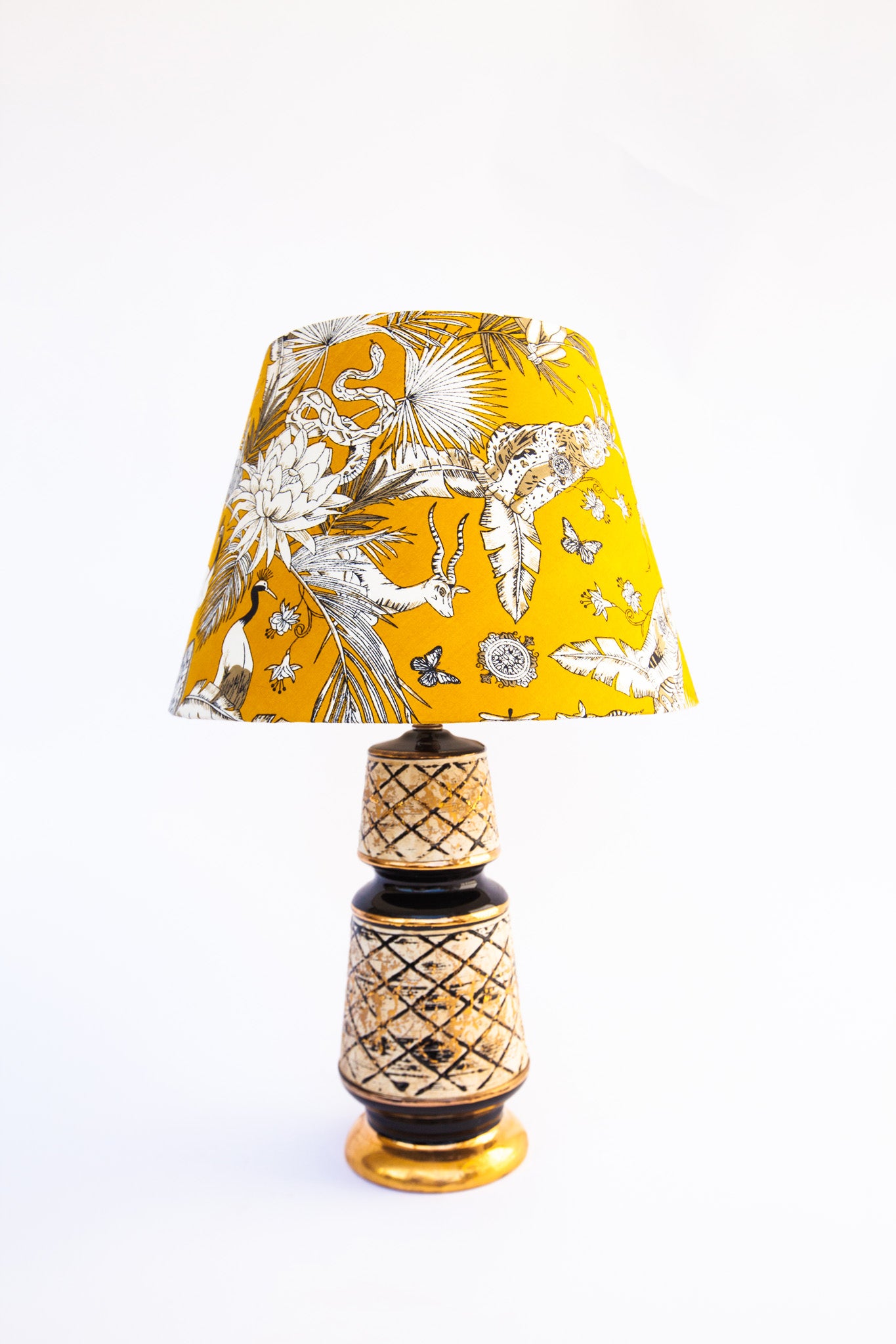white and mustard yellow lampshade on black and beige lamp