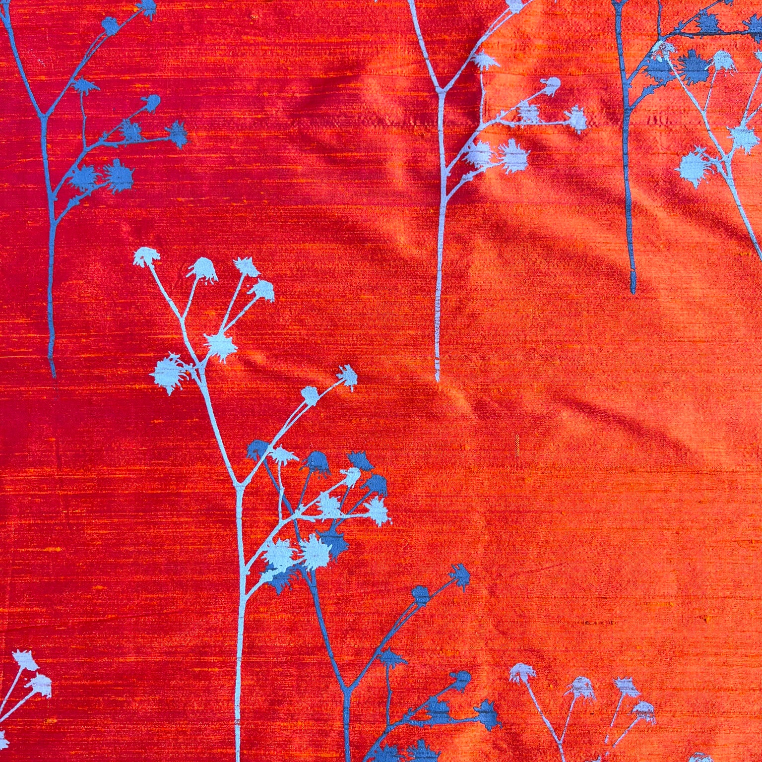 red silk with light blue and indigo flowers fabric